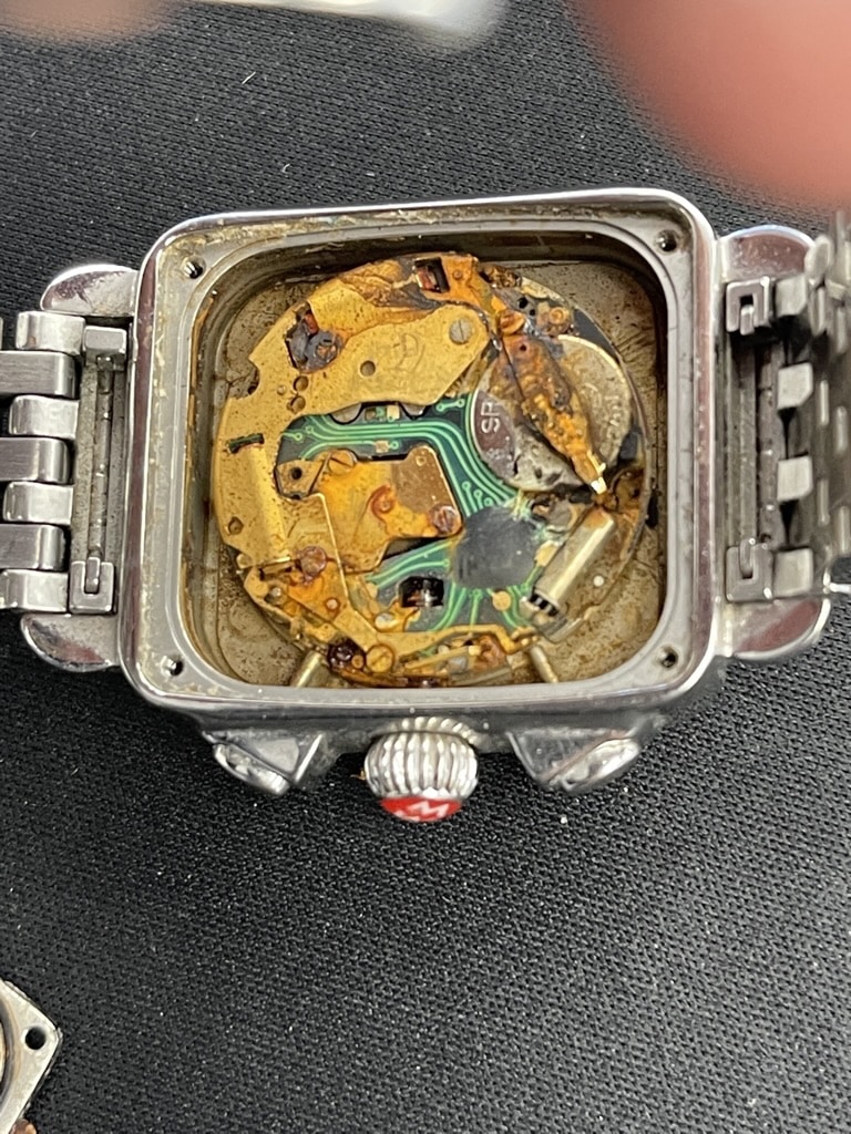 Severely Water-Damaged Watch Movement Showing Heavy Corrosion, Rust On The Circuit Board And Components Caused By Failed Water Resistance Seals — The Kind Of Damage Preventable With Regular Pressure Testing