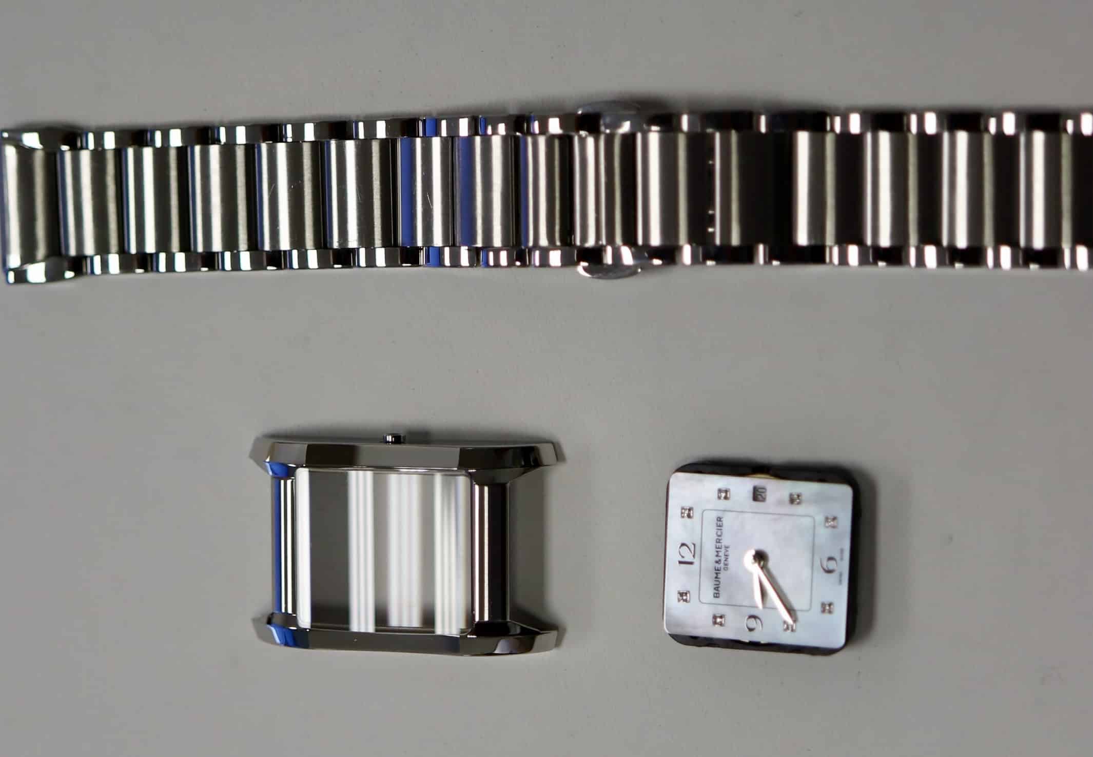 Baume &Amp; Mercier Watch Disassembled Showing Polished Case And Mother-Of-Pearl Dial During Crystal Replacement Service At Watch Technicians