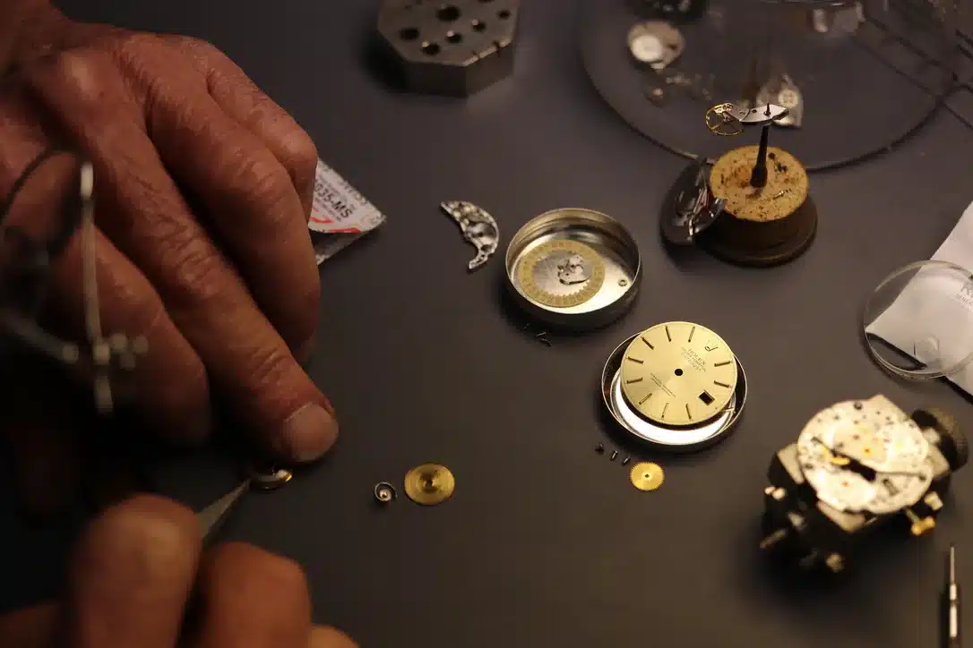 Certified Watchmaker Inspecting A Vintage Rolex Dial And Movement Components At Watch Technicians Creve Coeur St. Louis